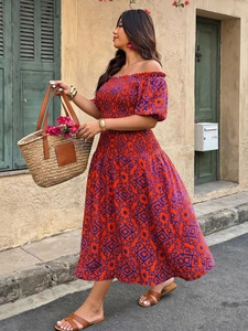 Detail of smocked off-shoulder bodice and red geometric print on a summer maxi dress