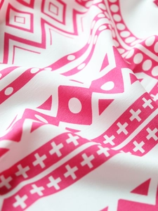 Detail of pink and white geometric pattern fabric with intricate ethnic textures and prints