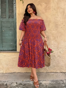 Detail of smocked off-shoulder bodice and retro geometric pattern on summer midi dress