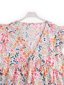Close-up of V-neck floral chiffon top with pink flowers and ruffled shoulder details