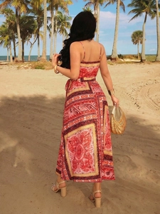 Detail of bohemian V-neck backless maxi dress with ethnic print in a beach setting
