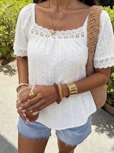 Detail of square neck lace patchwork and hollow out pattern on white cotton summer top