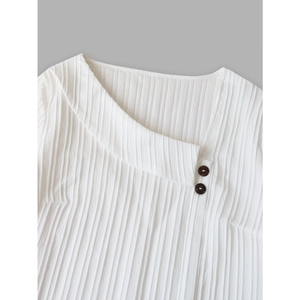 Plus size white blouse with asymmetric collar, textured fabric, and dark brown buttons