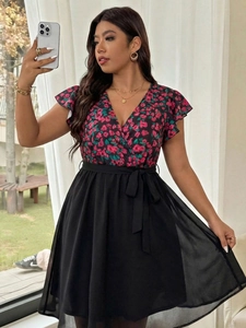 Detail of floral V-neck bodice with butterfly sleeves and a black chiffon wrap skirt