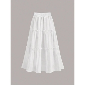Detail of white tiered cake skirt showing elastic waistband and ruffled cotton texture