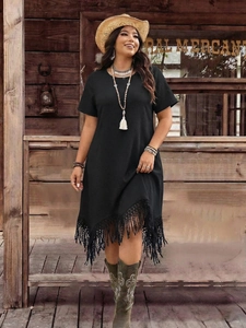 Detail of the black plus size waffle texture dress featuring irregular fringe hemline