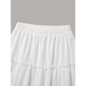 White tiered ruffle cake skirt featuring a comfortable elastic waist and lightweight fabric