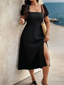 Detail of plus size black dress with square neck, puff sleeves and high side slit