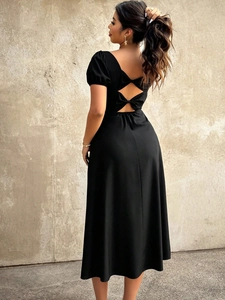 Detail of back cutout design with elegant double bows on black puff sleeve dress