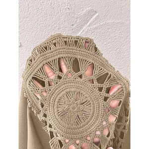 Detailed macro view of the intricate khaki crochet pattern and hollow knit texture on the top