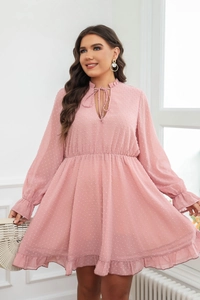 Detail of pink Swiss dot chiffon dress showing the V-neck tie and ruffled waist texture