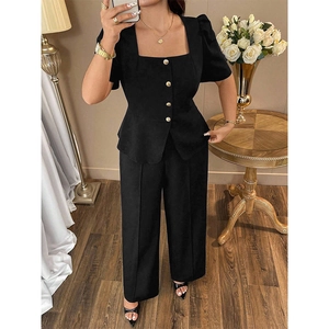 Detail of square neck puff sleeve top with gold buttons and high-waisted wide-leg pants