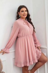 Close-up of pink Swiss dot fabric texture on ruffle v-neck plus size dress