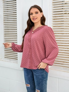 Detailed view of pink chiffon top with V-neck lace trim and polka dot texture