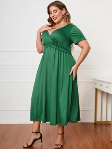 Detail of V-neckline and gathered waist on this plus size dark green maxi dress