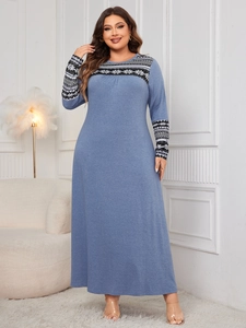 Detail of blue knit maxi dress featuring ethnic geometric snowflake patterns on the neckline