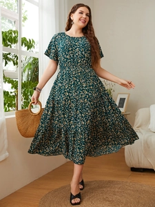 Detail of dark green floral maxi dress with elastic waist and yellow flower patterns