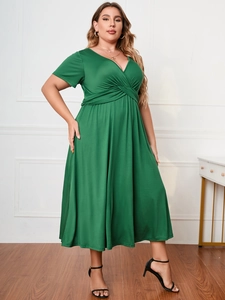 Detail of dark green plus size maxi dress with deep V-neck and pleated waist design