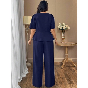 Rear view of navy blue two-piece set featuring short sleeve top and wide leg trousers