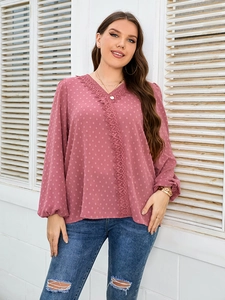 Detail of pink Swiss dot chiffon shirt with delicate lace trim and v-neckline
