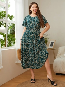 Full view of plus size dark green floral tiered dress with high waist and short sleeves