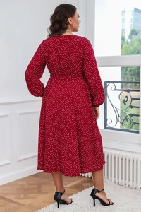 Vue détaillée d'une robe rouge à pois grande taille montrant la coupe du dos et le drapé