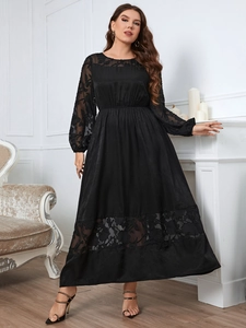 Detail view of the elegant lace embroidery on the sleeves of a black midi dress