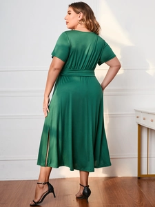 Detail of dark green plus size maxi dress featuring a waist tie and side slit design