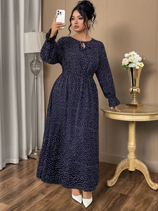 Detail of navy blue polka dot maxi dress featuring elastic waist and ruffled cuffs