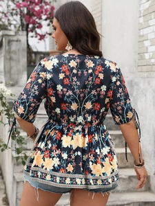 Detail of V-neck floral peplum top with tie sleeves and ruffled hem in bohemian style
