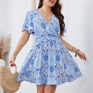 Detail view of blue vintage bohemian print dress with V-neckline and high waist design