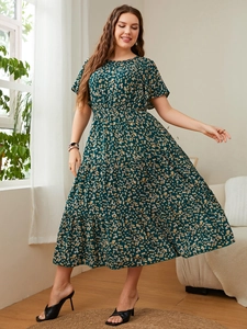 Detail view of dark green floral maxi dress with tiered ruffle skirt and short sleeves