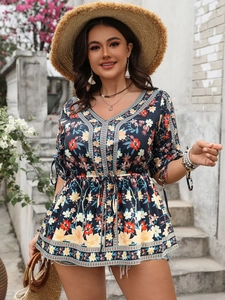 Detail of bohemian floral print on V-neck top with ethnic ribbon and drawstring waist