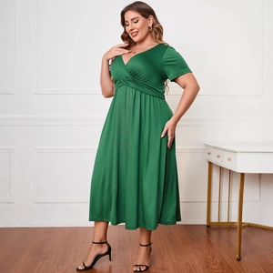 Plus size dark green V-neck short sleeve dress with a high waist and pleated maxi skirt