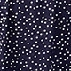 Detailed close-up of white polka dot pattern on dark blue fabric for women dress