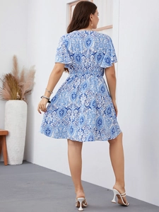 Rear view of a blue and white floral printed midi dress with ruffle sleeves and A-line hem