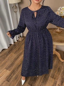 Detail of navy polka dot midi dress with adjustable tie-neck and elastic waist