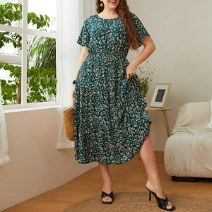 Detailed close-up of dark green floral plus size dress with yellow and white prints