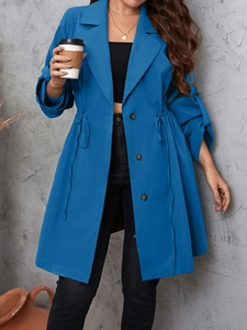 Detail of a deep blue mid-length trench coat featuring an adjustable drawstring waist design