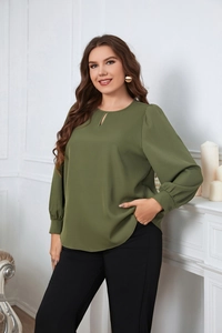 Detail view of olive green blouse featuring a teardrop cutout neckline and pleated cuffs
