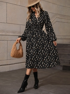 Detail of elegant black polka dot V-neck dress with long sleeves and elastic high waist