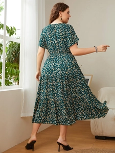Detail view of dark green floral maxi dress featuring a high waist and layered skirt tiers