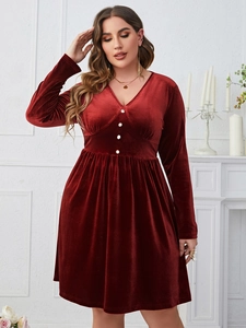 Detailed view of burgundy velvet dress with V-neckline and elegant white buttons