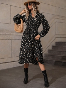 Close-up of lightweight black chiffon floral dress with elegant V-neck and elastic waist