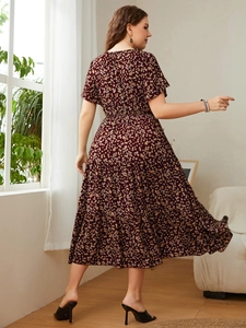 Detail of a dark red floral tiered dress with short sleeves and high waist design
