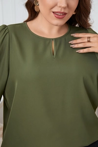 Close-up of olive green blouse featuring a keyhole neckline and pleated puff sleeves
