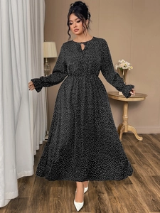 Close-up of black polka dot maxi dress with elastic waist and tie-neck detail