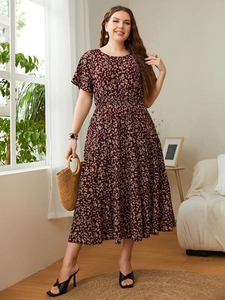 Detailed view of women's floral midi dress featuring elastic waist and casual round neck