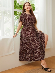 Detail of a deep red tiered maxi dress with floral print and elastic waist design