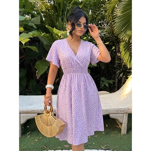 Detail of V-neckline and flutter sleeves on a purple floral summer midi dress